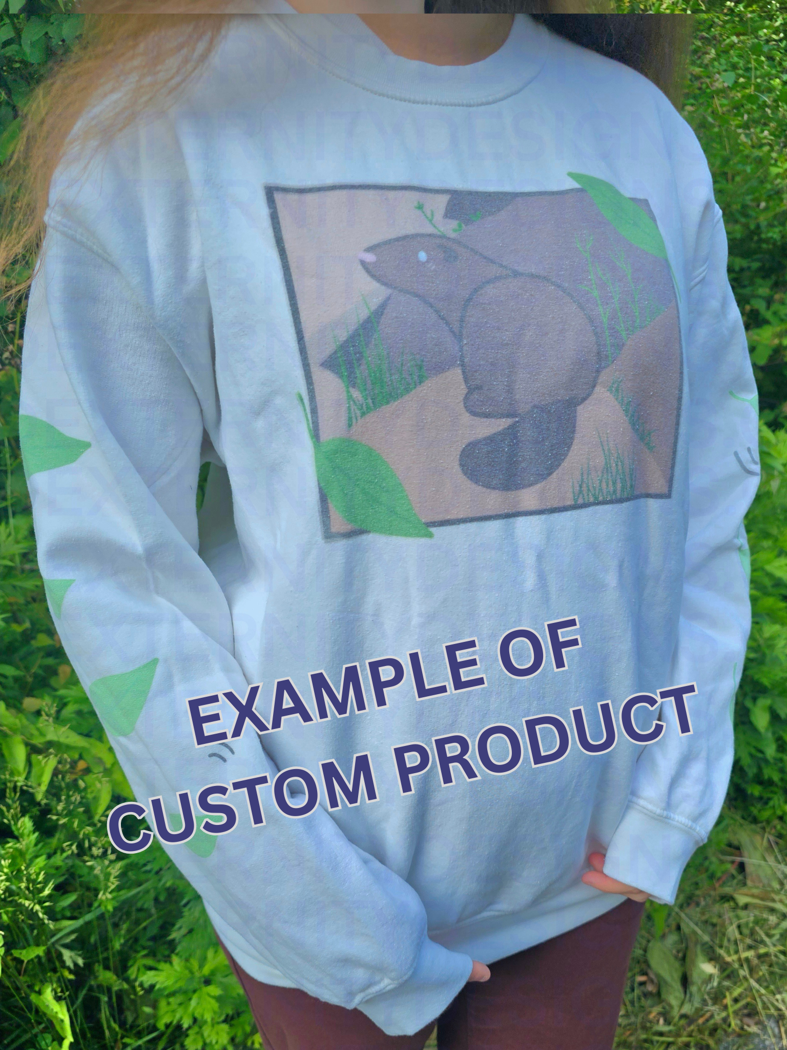 A person wearing a white sweatshirt featuring a groundhog drawing on the chest and leaves on the sleeves. Text on the bottom reads "EXAMPLE OF CUSTOM PRODUCT".