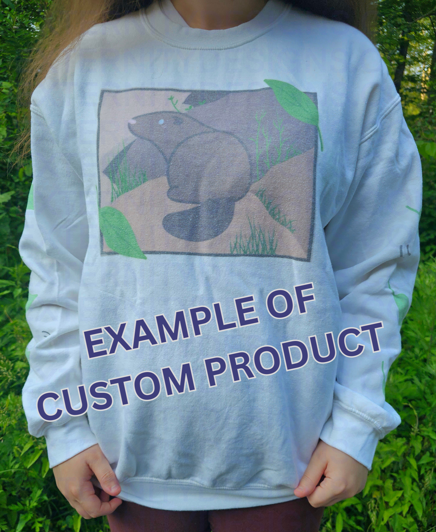 A person wearing a white sweatshirt featuring a groundhog drawing on the chest and leaves on the sleeves. Text on the bottom reads "EXAMPLE OF CUSTOM PRODUCT".